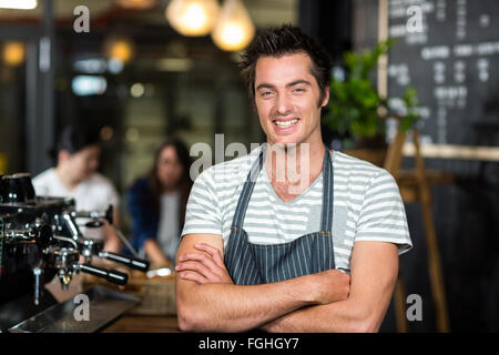 Smiling barista with arms crossed Stock Photo