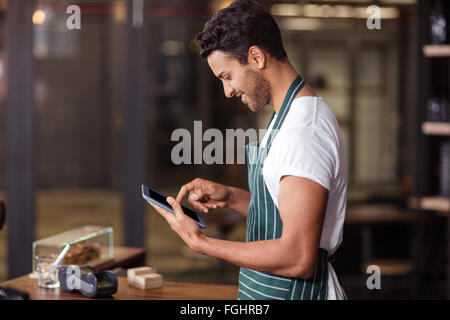 Smiling barista using tablet Stock Photo
