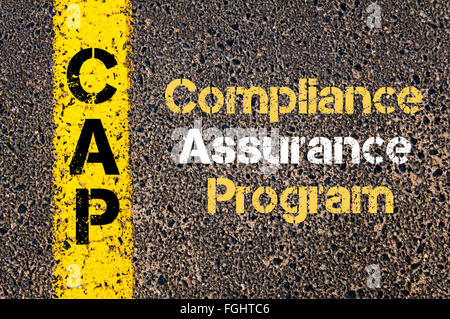 Concept image of Business Acronym CAP Compliance Assurance Program written over road marking yellow paint line Stock Photo