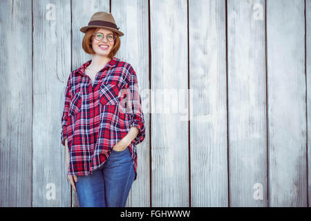 smiling hipster woman with her hand in her pocket