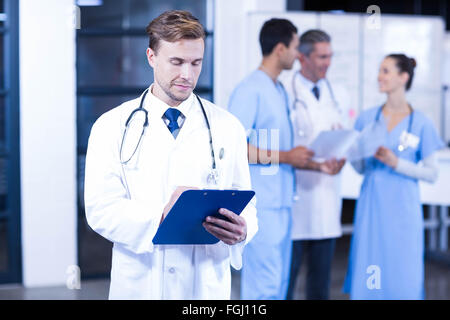 Doctor writing a medical report Stock Photo
