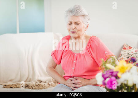 Senior woman suffering from stomach pain Stock Photo