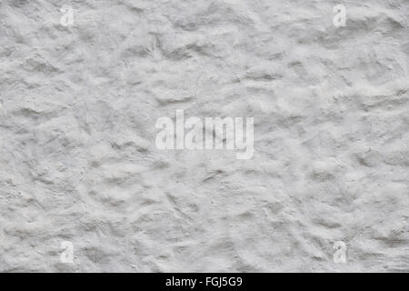 Rough white wall surface of decorative embossed painted lime plaster texture background Stock Photo
