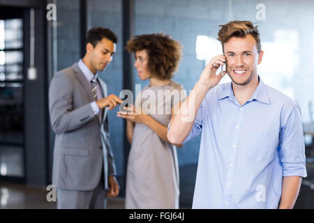 Confident executive talking on mobile phone Stock Photo