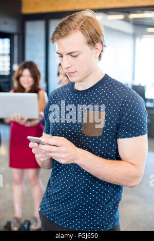 Man text messaging on smartphone Stock Photo