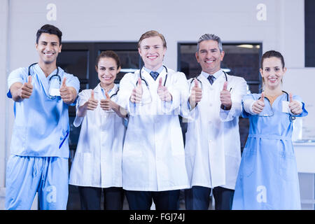 Medical team putting their thumbs up and smiling Stock Photo