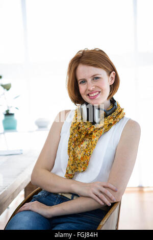 smiling hipster business woman sitting at her desk Stock Photo