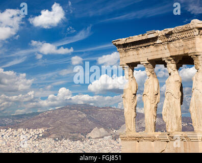 Athens - The statues of Erechtheion on Acropolis and the town in morning light. Stock Photo