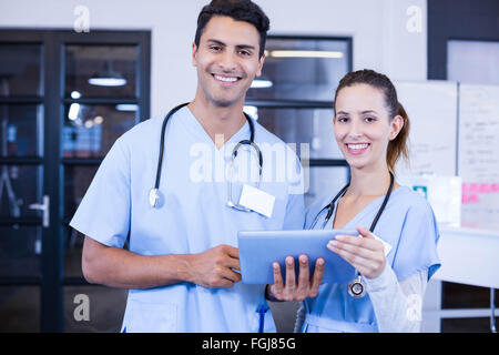 Portrait of doctors using digital tablet and smiling Stock Photo