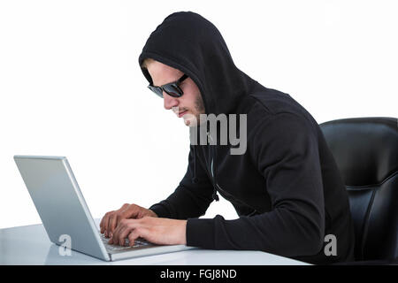 Man in black hoodie using laptop Stock Photo