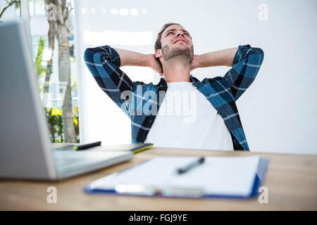 Handsome man relaxing on his desk chair Stock Photo