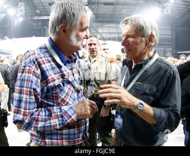 Mojave, California, USA. 19th February, 2016. L-R) Aviation pioneer Burt Rutan talks with actor Harrison Ford, during the Virgin Galactic roll out of a new version of its SpaceShipTwo space tourism rocket Friday as it prepares to return to flight testing for the first time since a 2014 accident destroyed the original, killed one of its pilots and set back the nascent industry.The space line founded by Sir Richard Branson unveils the craft at California's Mojave Air & Space Port, where it was assembled. Credit:  ZUMA Press, Inc./Alamy Live News Stock Photo