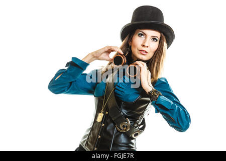 Beauty and fashion - retro style. Vintage pretty woman in black hat topper and old goggles isolated on white. Stock Photo