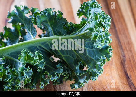 Green curly kale on bamboo cutting board Stock Photo ...