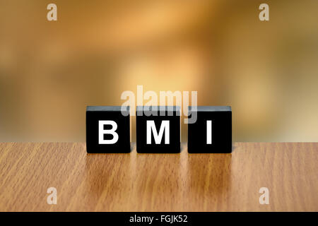 https://l450v.alamy.com/450v/fgjk52/bmi-or-body-mass-index-on-black-block-with-blurred-background-fgjk52.jpg