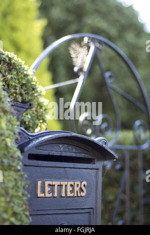 A letter box and gate and rural England Stock Photo