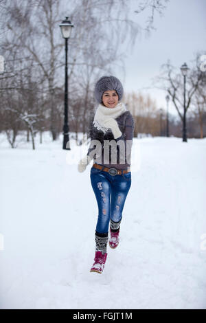 Girl playing with snow in park . Stock Photo