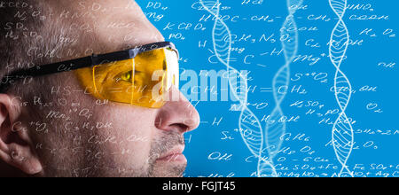 man in glasses working on a blue background Stock Photo