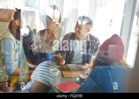 Friendly teens spending free time in cafe Stock Photo