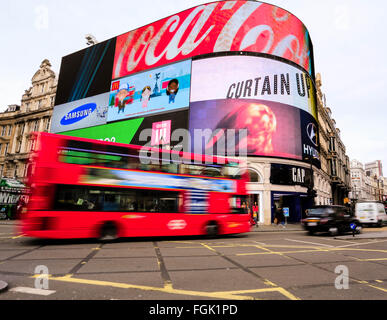 Red London bus and Black Taxi passing Picadilly Circus London Stock Photo