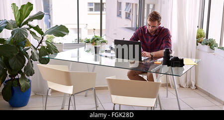 Businessman busy working from his desk at home Stock Photo