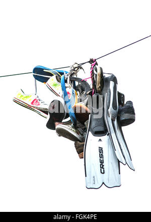 Collection Of Trainers and Flippers hanging from a telephone line Bristol, UK Stock Photo