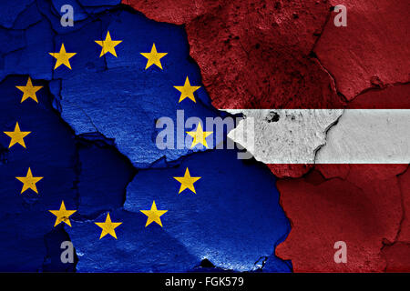 flags of EU and Latvia painted on cracked wall Stock Photo