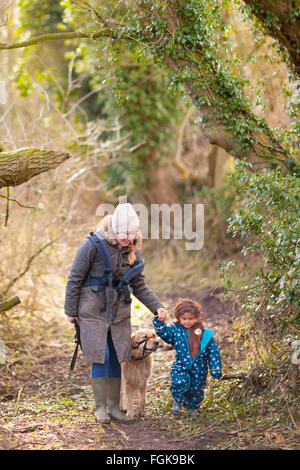 A March woodland walk for mother and three year old boy. Stock Photo