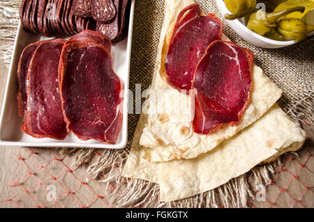 Thin bread with slices dried salted beef coated spices Stock Photo