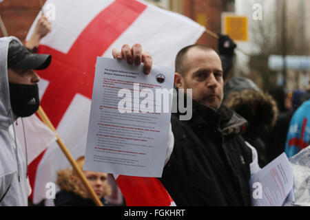 Preston, Lancashire, UK. 20th February, 2016. EDL protest in Preston, UK. A member of the EDL holds up a leaflet during a march through Preston, UK 20th February 2016 Credit:  Barbara Cook/Alamy Live News Stock Photo