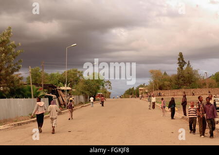 KOMBOLCHA, ETHIOPIA-MARCH 24, 2013: Local people stroll under stormy skies on Sunday evening after having attended church, Stock Photo