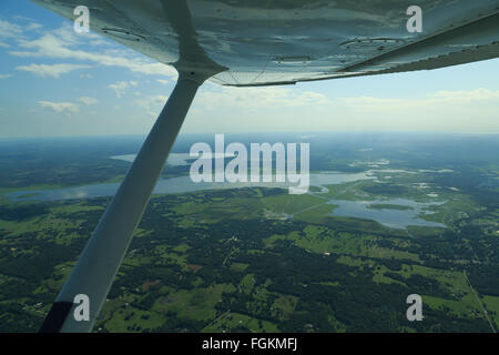 An aerial photograph of some wetlands near Gainesville in Florida, USA. The plane wing is from a 1970's Cessna airplane. Stock Photo