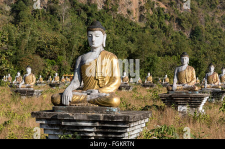 Buddha statues lined up in rows at the foot of Mt Zwegabin, Hpa-an, Karen (Kayin) State, Burma Stock Photo