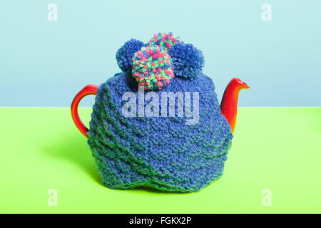 Teapot with knitted cosy Stock Photo