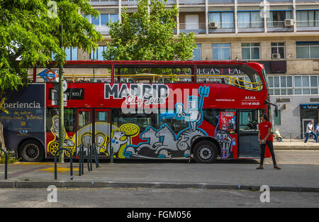 View of a touristic red bus in a street of Madrid city, Spain Stock Photo