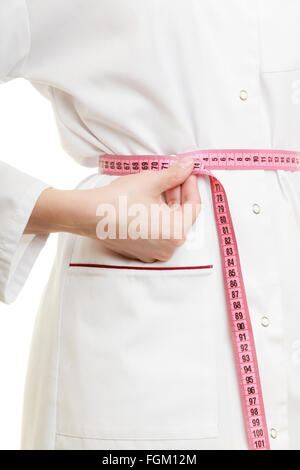 Slim down dieting concept. woman in white lab coat . Doctor specialist dietitian measuring her waist isolated. Stock Photo