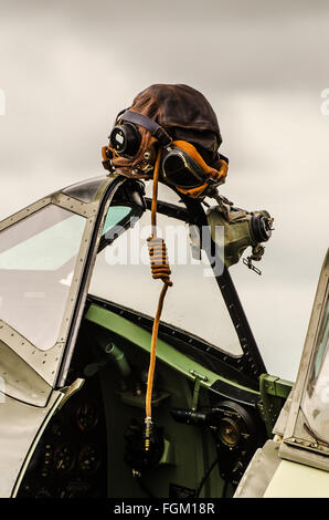 A Spitfire ready to display at an airshow, with cockpit canopy open and pilot helmet hanging over the rear view mirror Stock Photo