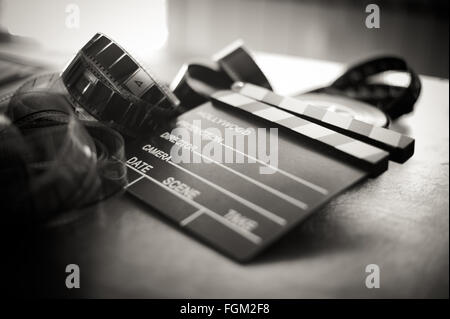 Movie clapper board and filmstrip selective focus and vintage black and white Stock Photo