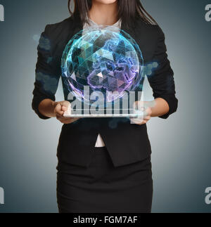 Young girl holding tablet in the hands of virtual digital globe Stock Photo