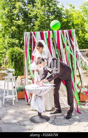 Wedding ceremony. Wedding couple leaving their signatures Stock Photo