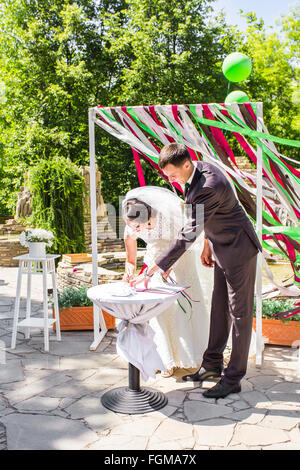 Wedding ceremony. Wedding couple leaving their signatures Stock Photo