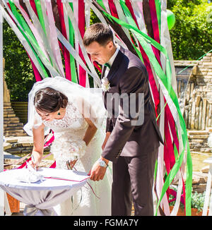 Wedding ceremony. Wedding couple leaving their signatures Stock Photo