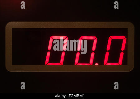 Red seven-segment LED display on electronic weight scale panel showing zero. Stock Photo