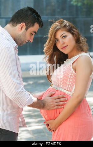 Pregnant woman with hands husband touching belly pregnancy concept