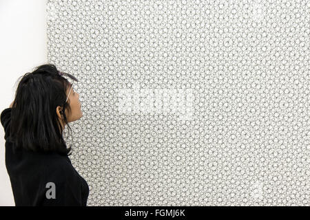 Woman watches the picture 4 doubles trames from Francois Morellet Stock Photo