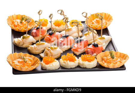 set canapes with different fish and caviar on black plate Stock Photo
