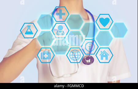 Doctor presses on a digital screen with icons in honecomb Stock Photo