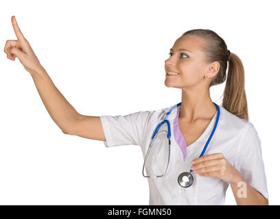 Healthcare. Smiling female doctor pointing to something or pressing imaginary button Stock Photo