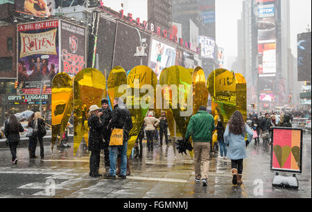 People at the Heart of Hearts art installation for Valentine's Day in Times Square, New York, in the snow Stock Photo