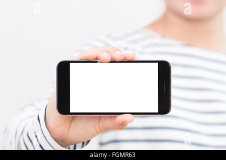 woman holding phone white screen selective focus on hand showing Stock Photo